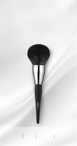 Close-up of professional large powder brush with soft black bristles and matte handle