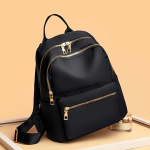 Minimalist black oxford cloth backpack for women with golden zippers and large capacity