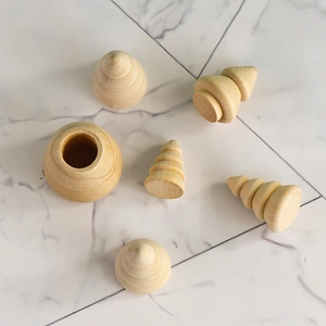 DIY unfinished wooden Christmas tree ornaments set on white marble surface