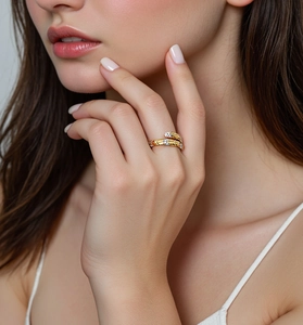 Detail of a bicolored S925 silver snake feather ring with zircon stones on a model's hand