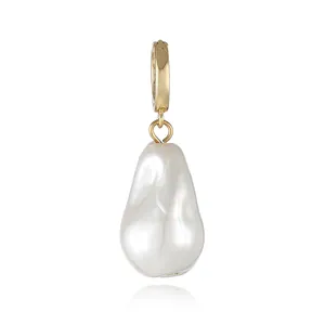 Macro detail of 18k gold plated ring clasp with a natural baroque pearl pendant