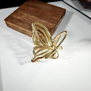 Elegant gold alloy butterfly hair claw clip with a hollow design on white surface