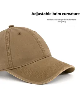 Detail of a brown cotton baseball cap featuring a wide curved brim and reinforced stitching