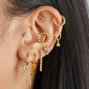 Close-up of S925 sterling silver gold stud earring set with sparkling cubic zirconia