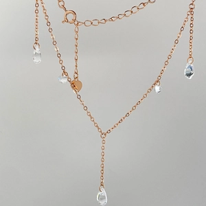 Detailed view of rose gold Y-necklace with sparkling water drop zircon tassels and pendants