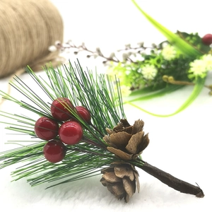 Artificial pine needles with red berries and pine cones for Christmas decoration