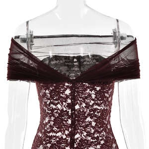 Detailed close-up of dark red lace texture and sheer mesh pleats on the off-shoulder dress