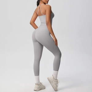 Back view detail of light gray yoga jumpsuit featuring cross thin straps and slimming fit