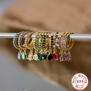 Close-up of S925 sterling silver hoop earrings with colorful teardrop gemstones and diamonds
