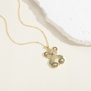Detailed view of a gold teddy bear pendant inlaid with colorful sparkling zircon stones