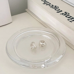 Minimalist 925 sterling silver oval stud earrings displayed on a glass tray