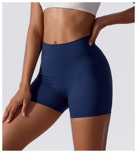 Close-up of high-waisted dark blue yoga shorts showing elastic fit and smooth matte fabric