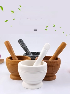 Detail view of mortar and pestle sets in white marble and varied wood grain finishes
