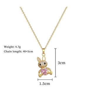 Detail view of gold plated rabbit necklace with pink heart gemstone and zircon pavé