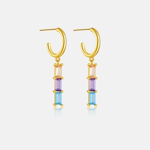 Macro view of gold 925 sterling silver earrings with square rainbow zircon stones