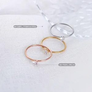 Minimalist titanium steel rings with 18k gold plating and six-prong cubic zirconia