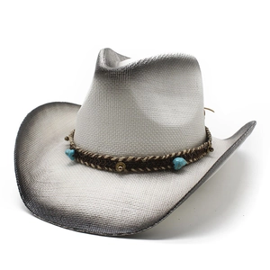 Detail of hand-woven straw cowboy hat with black spray paint edge and turquoise beads