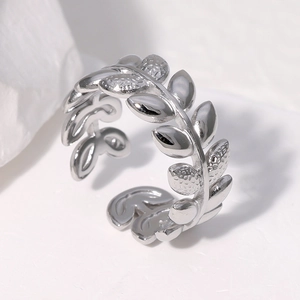 Adjustable silver leaf ring in stainless steel displayed on a textured stone background