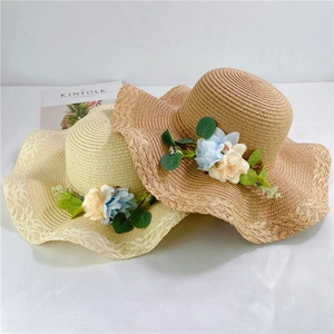 Women's wide brim straw hats with floral decor and wavy edges for beach sun protection