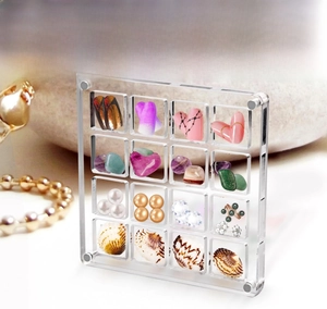 Macro view of 16-compartment clear acrylic storage box for beads and jewelry crafts
