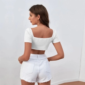 Back view of a white knitted crop top and matching frayed denim shorts set
