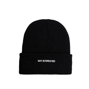 Minimalist black knitted beanie with white embroidery NOT INTERESTED text for autumn