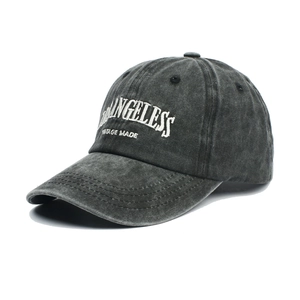 Macro detail of vintage washed cotton fabric and 3D embroidery on the gray baseball cap