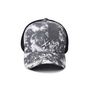 Detail view of tie-dye trucker hat featuring graffiti print and breathable black mesh back