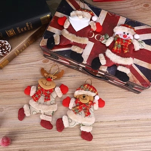 Detail of Christmas plush pendants with Santa, snowman and deer on rustic wooden background