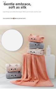 Close-up of coral fleece towels with 3D cat ears and embroidered kitten facial details
