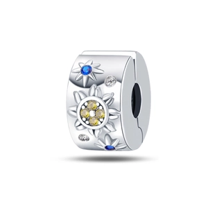 Detailed view of silver charm with blue and yellow zircons for DIY jewelry making