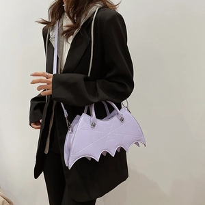 Detail view of purple bat-shaped bag with spider web embroidery and PU leather texture
