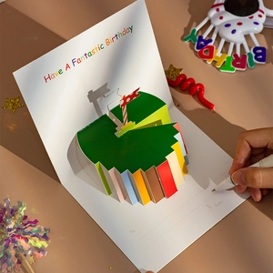 3D pop-up birthday card featuring a colorful cake design with handwritten greeting