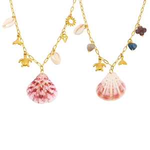 Golden sea turtle and fish tail necklaces with pink shell pendants on white background