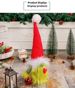Grinch-style Christmas gnome with green fur and red heart in a festive indoor setting