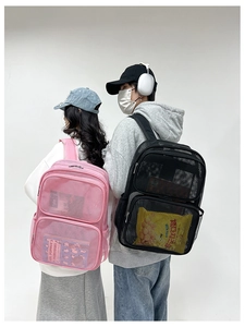 Detail view of pink and black breathable mesh backpacks on models in a studio setting