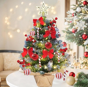 Mini tabletop Christmas tree with red bows, pine cones, and warm LED light string