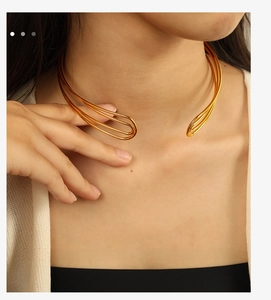 Close-up of a minimalist golden multi-wire choker necklace with a sleek C-shaped design