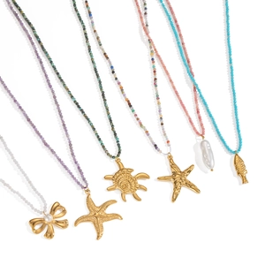 Ocean style beaded necklace set with starfish, turtle and bow pearls in gold finish
