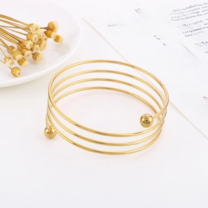 Elegant multi-layer spiral stainless steel bracelet in gold finish with ball ends