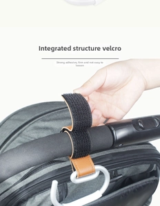 Close-up of durable brown leather stroller hook with strong Velcro strap and metal D-ring