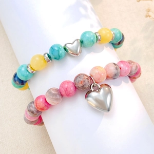Bracelets en perles colorées avec pendentifs en cœur sur support, style minimaliste