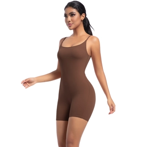 Detail of dark brown yoga bodysuit featuring thin straps and body-sculpting fabric