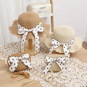 Close-up of kids straw hat and matching bag set with polka dot bows in two colors