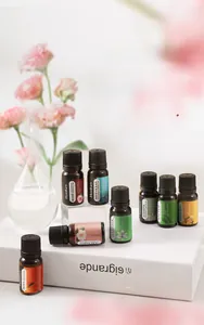 Vue détaillée de flacons d'huiles essentielles 10ml avec fleurs et supports
