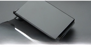 Detailed macro view of the sleek black aluminum card slot with high-quality leather finish