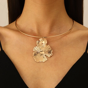 Vintage gold choker necklace with overlapping large petal pendants on a female model