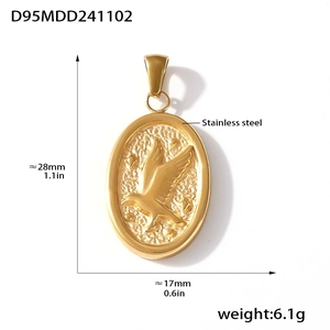Macro view of a 18K gold plated oval pendant with embossed bird on stainless steel