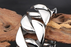 Macro detail of high-polished silver stainless steel Cuban link bracelet for men