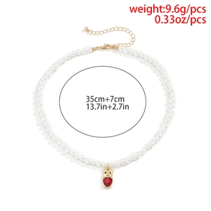 Detail of pearl necklace with gold bear pendant and red heart gem, 35cm with extender